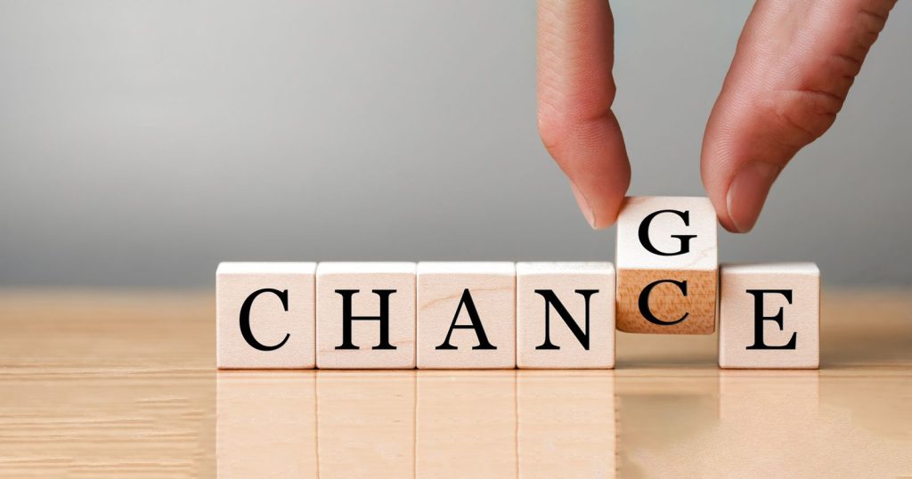 Hand flip wooden cube with word "change" to "chance", Personal d